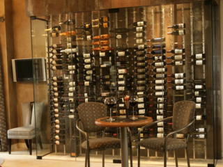 Single wall wine storage enclosed with glass doors for temperature control.