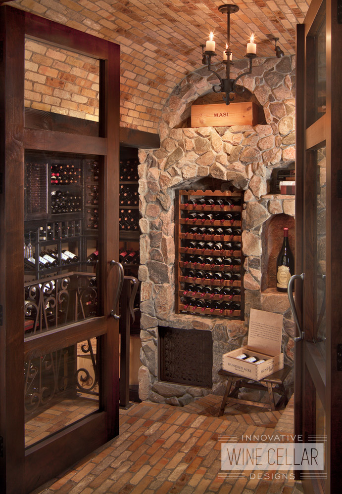 Stone & brick wine cellar with reclaimed wine barrel racking, custom design & install by Innovative Wine Cellar Designs.