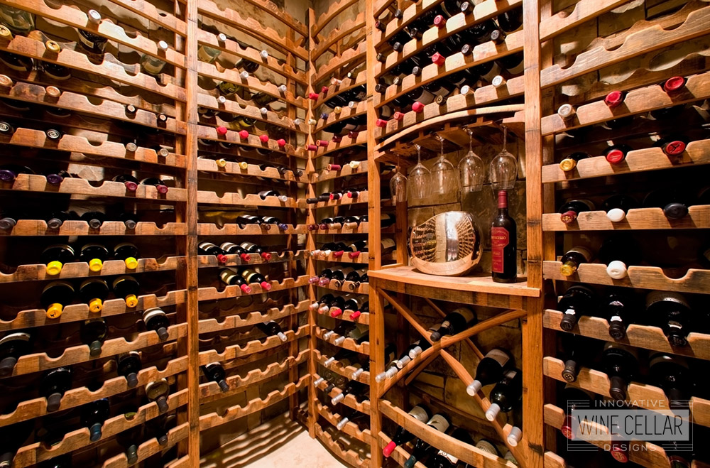 Custom reclaimed wine barrel wine racking for wine storage room.