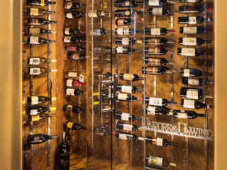 Converted corner into recessed wine wall storage room with glass doors.