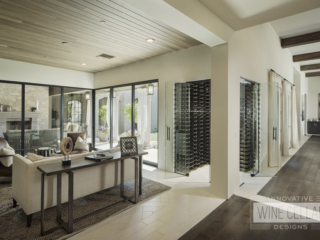 Dual sided entry wine cellar with glass doors and walls to match rustic contemporary decor.