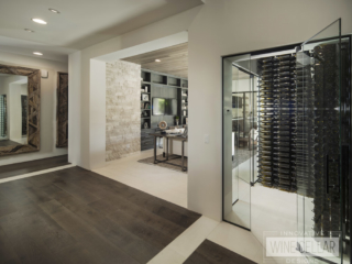 Dual entry wine cellar with glass doors and walls to match contemporary decor.