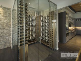 Corner room wine cellar with glass facing walls and wood racks with stone style back walls.