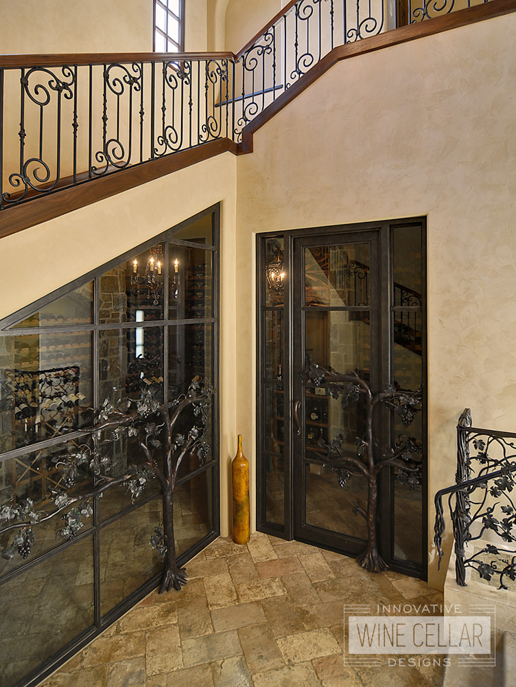 Under stairs custom wine cellar using reclaimed wine barrels, created by Innovative Wine Cellar Designs.