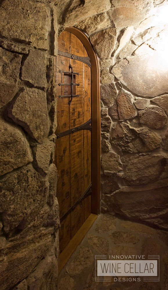 Custom Old World Style Wine Cellar Door made from Solid Wood and Iron Accents by Innovative Wine Cellar Designs.