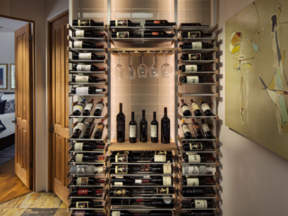 Modern open space wine storage using metal and wood accent wine bottle and glass racking.