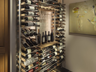 Modern open space wine storage using metal and wood accent wine bottle and glass racking.