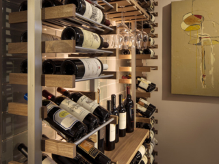 Modern open space wine storage using metal and wood accent wine bottle and glass racking.