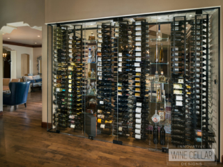 This glass wine wall cellar makes for a space saving, unique way to separate two rooms.