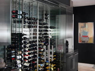 Modern kitchen glass wine cellar, custom design & install by Innovative Wine Cellar Designs.