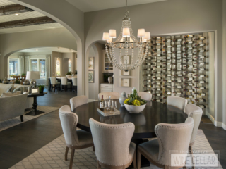 Recessed glass wall wine storage storage room located in contemporary styled dining room area.