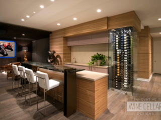 Wet bar area with converted end cap wall into wine storage area with glass walls.