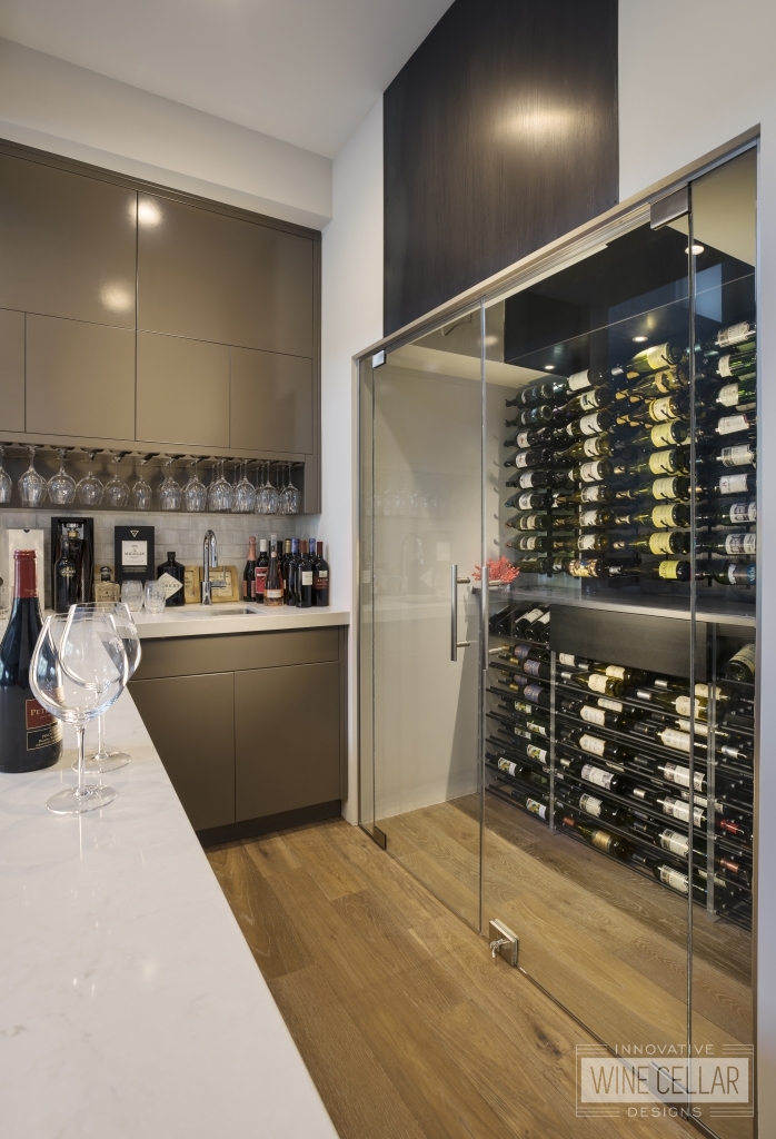 Contemporary small glass wine cellar in residential wet bar