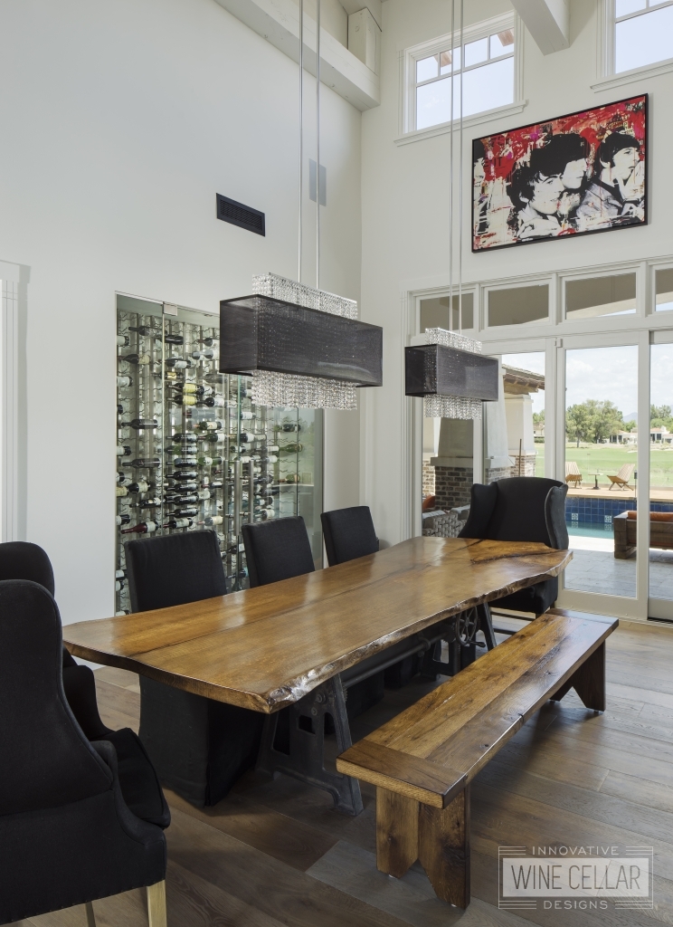 Urban contemporary dining room with glass wine wall