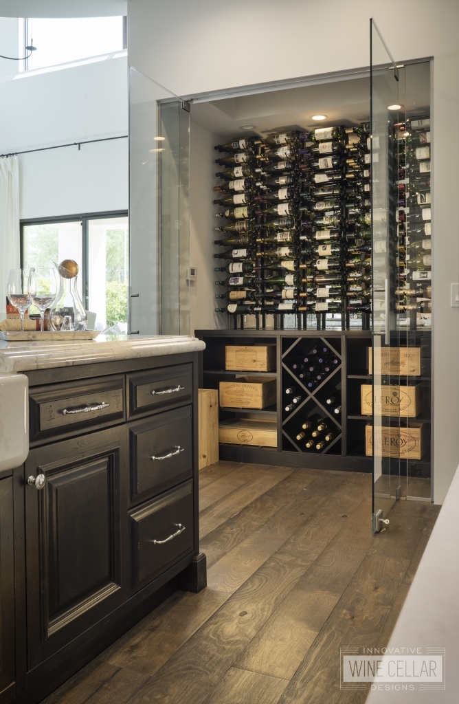 wine cellar in kitchen with glass doors