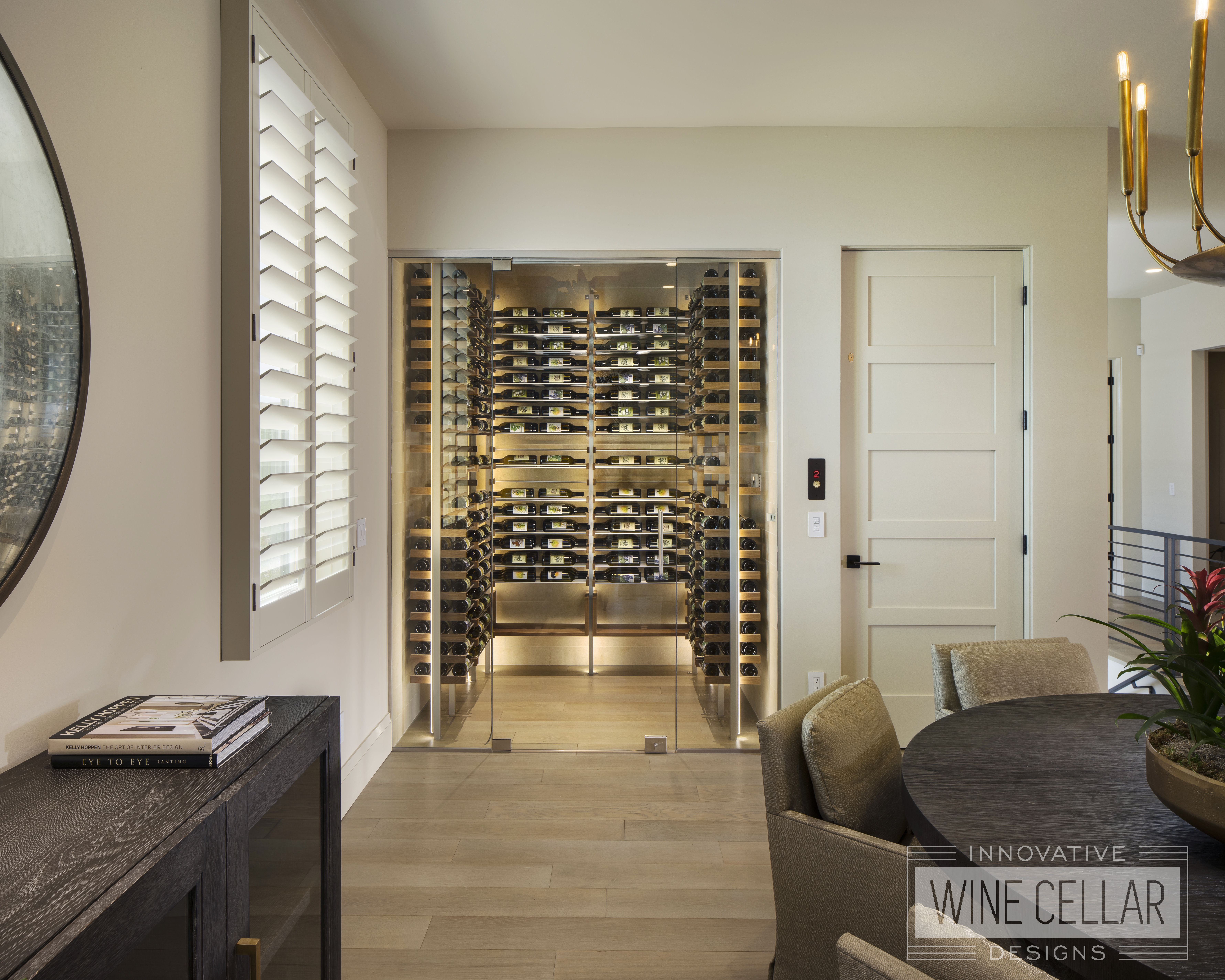 contemporary wine closet with accent lighting and glass doors