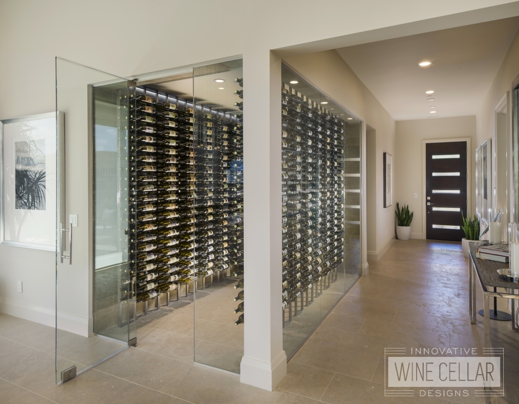 walk in glass wine cellar with floor to ceiling metal wine racks